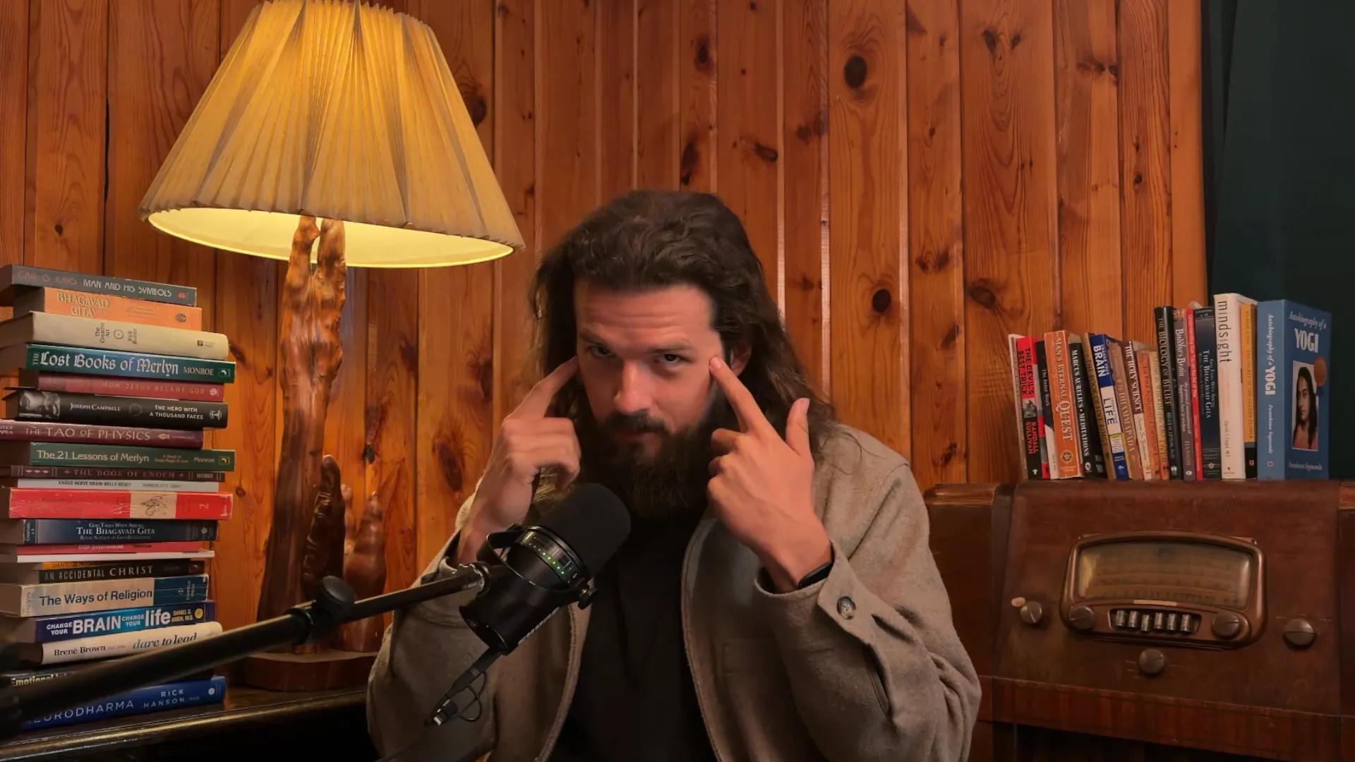 Nick Zei recording the podcast in his book-lined study